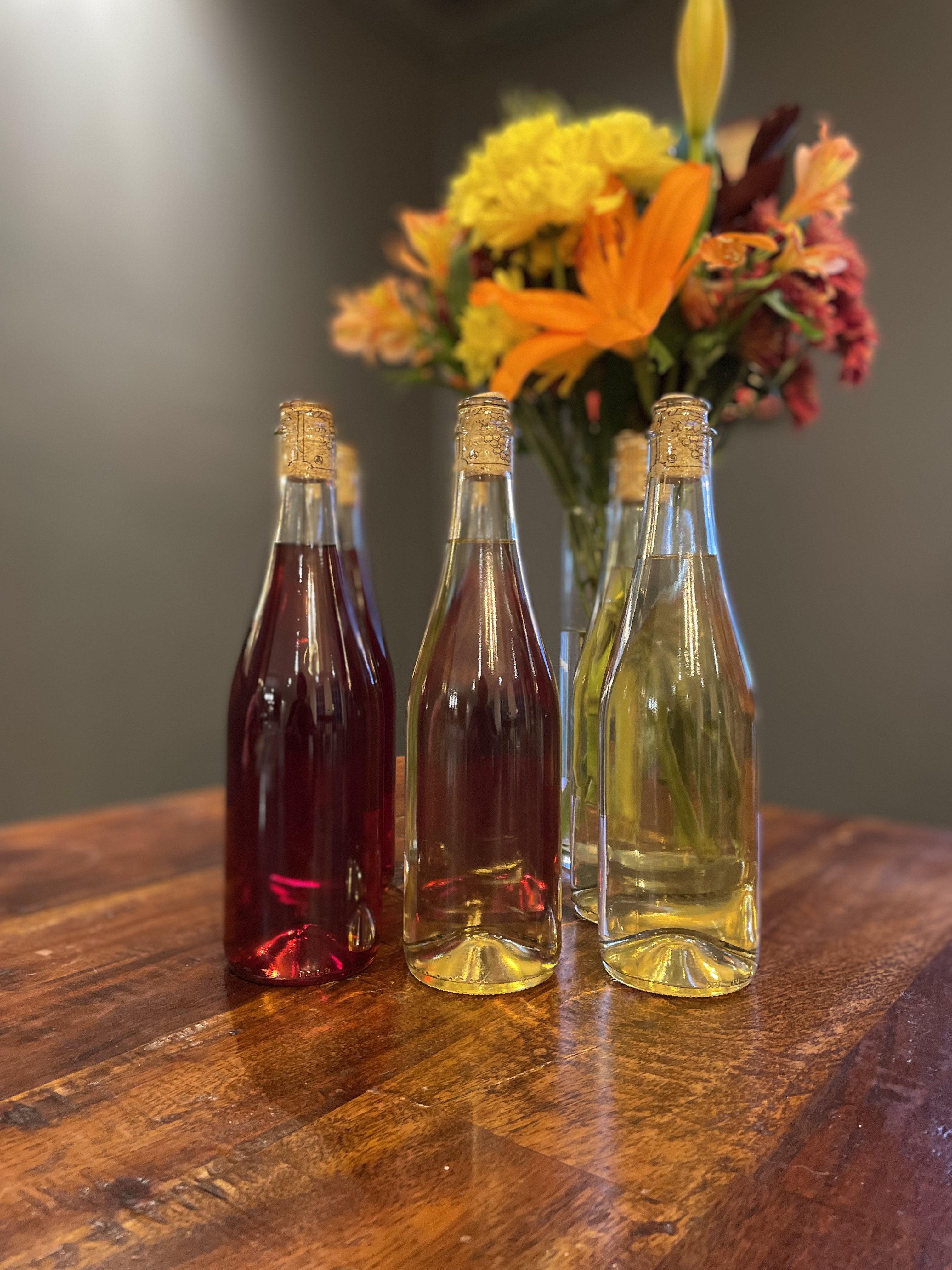Mead bottles and a vase of flowers